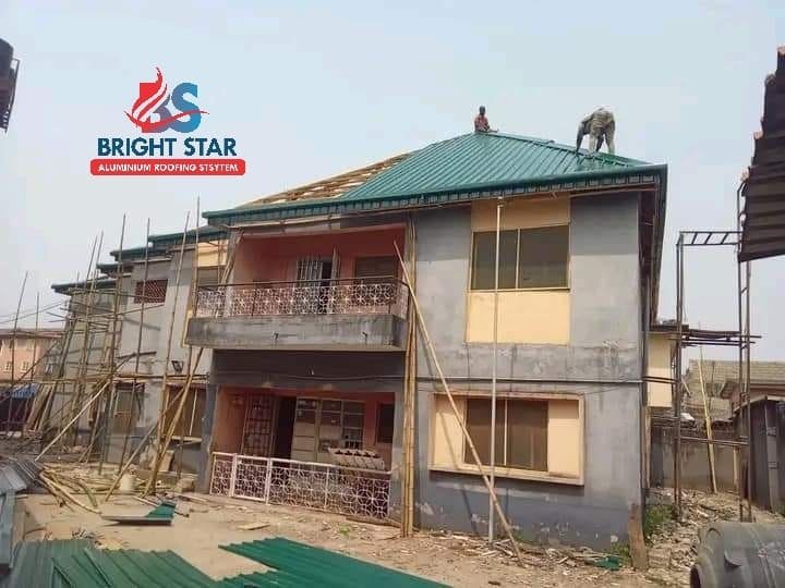 Roofers installing a green roof on a duplex